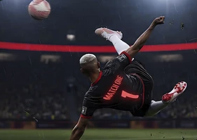 In-game bicycle kick, striker mid-air against a stadium crowd